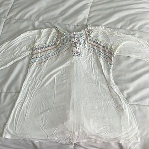 Taco Medium white half sleeve shirt. A little stain and two little rips.